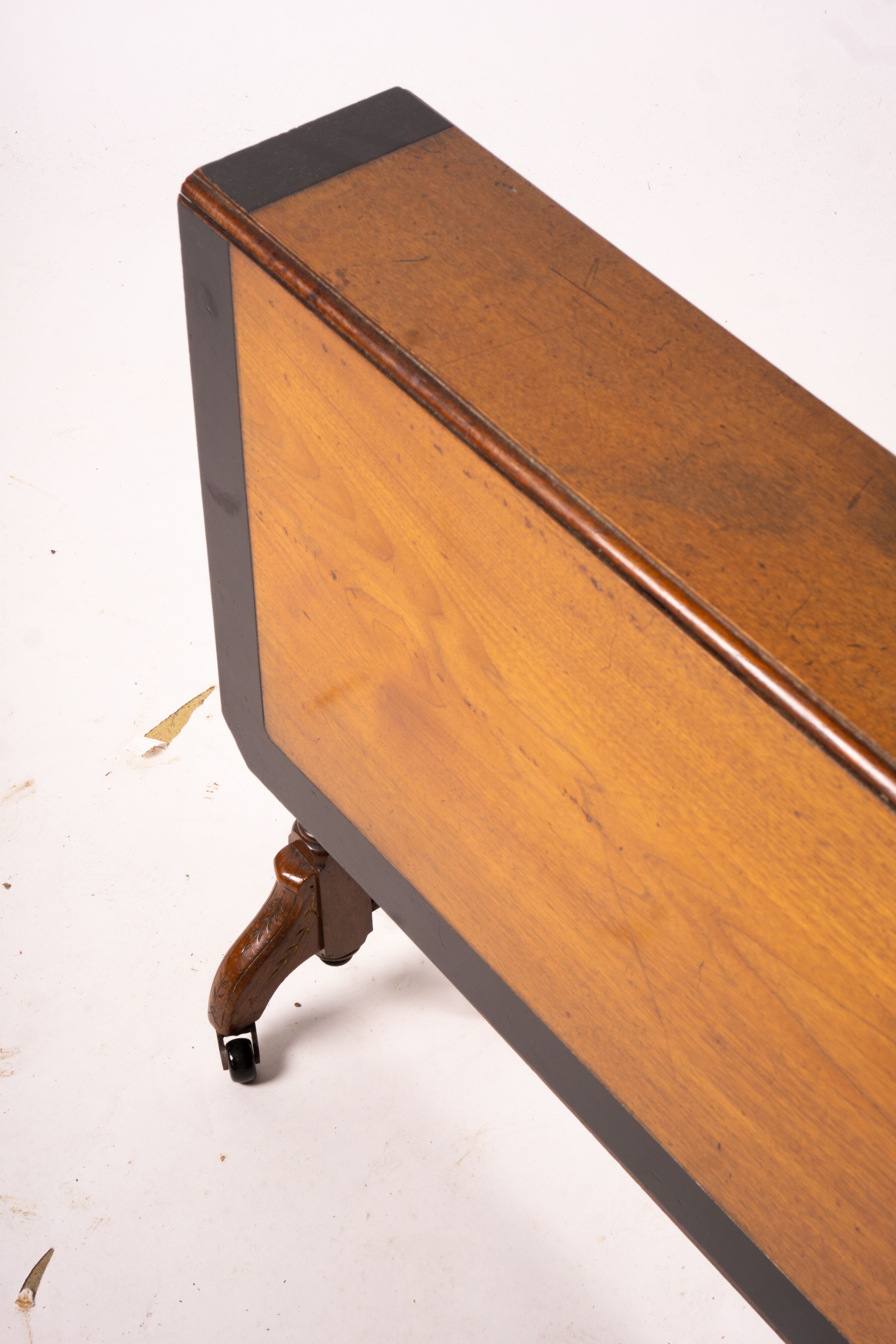 A late Victorian part ebonised walnut Sutherland table, width 76cm, depth 15cm, height 65cm